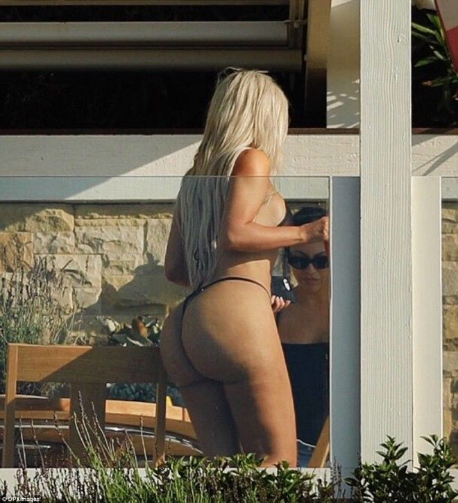 The most famous backside in the world Here Kim proved that her bottom is smooth as she wore a very risque suit